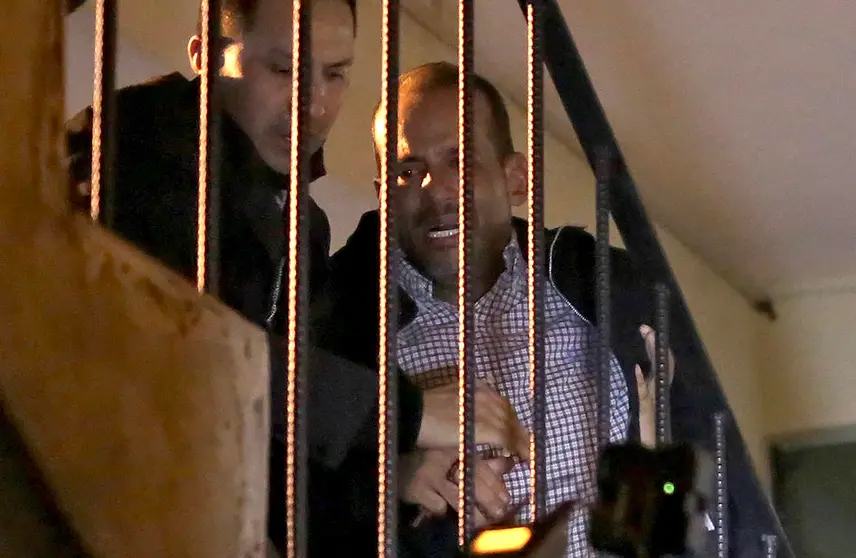 Luis Fernando Camacho (R), a key opposition figure and governor of the economic powerhouse Santa Cruz region, is escorted up a staircase upon arriving at the headquarters of the Special Forces for Fight against Crime (FELCC in Spanish) in La Paz, Bolivia, following his arrest on December 28, 2022. - Bolivian police on Wednesday arrested Luis Fernando Camacho, a key opposition figure and governor of the economic powerhouse Santa Cruz region, the government announced, without specifying the charges. Right-wing civic leader Camacho was under investigation on several charges, including for an alleged role in the resignation of leftist president Evo Morales in 2019, and for allegedly fanning protests in Santa Cruz this year. (Photo by LUIS GANDARILLAS / AFP)