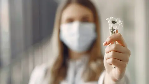 Medical student at the hall. Woman in a white uniform. Doctor in masks. Coronavirus theme.